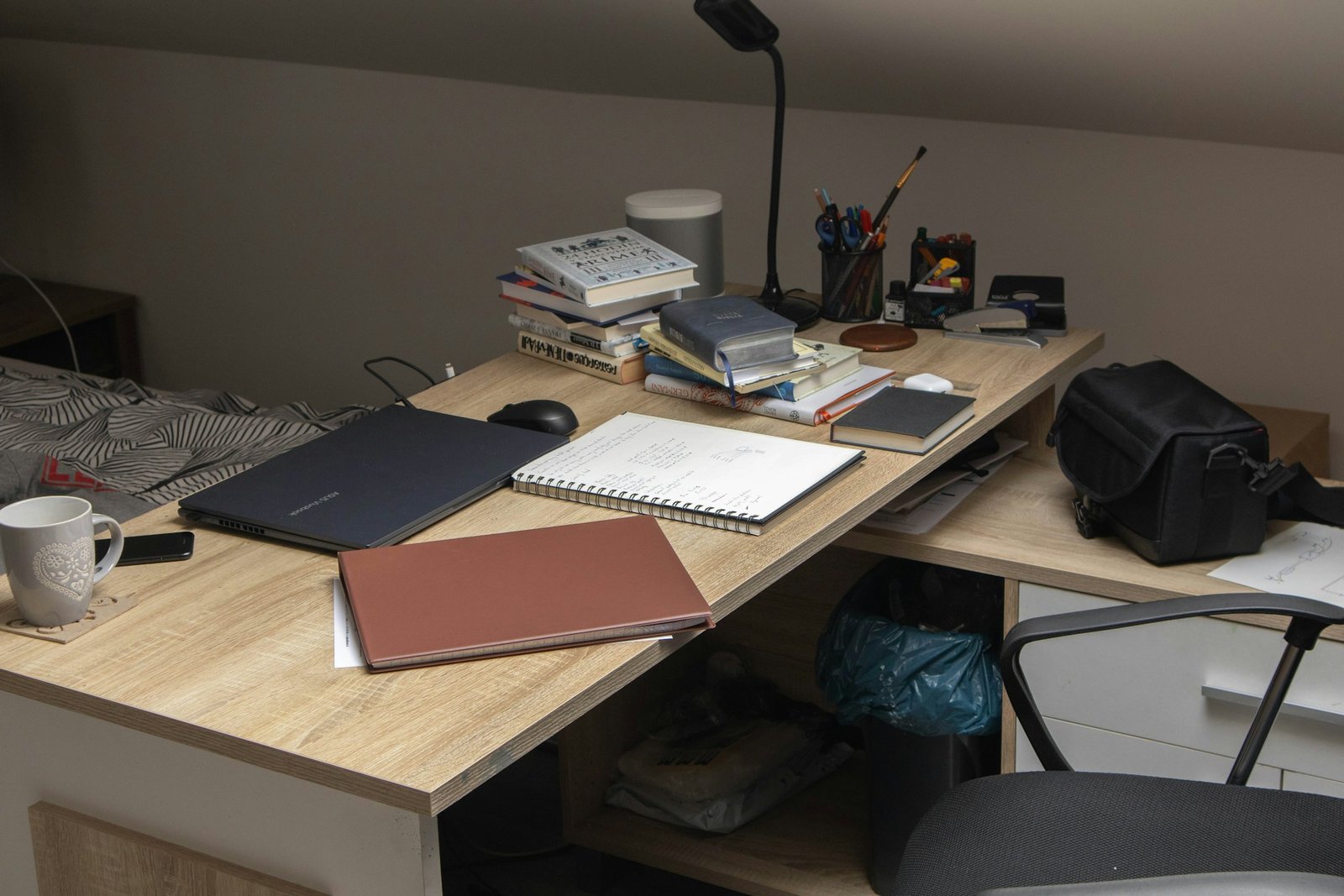 A wooden desk topped with a laptop computer